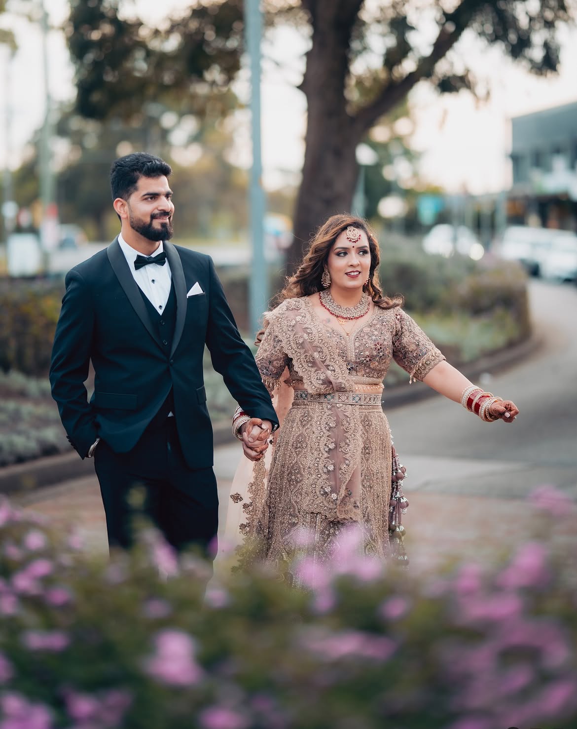 Couple walking hand in hand during their wedding portraits
